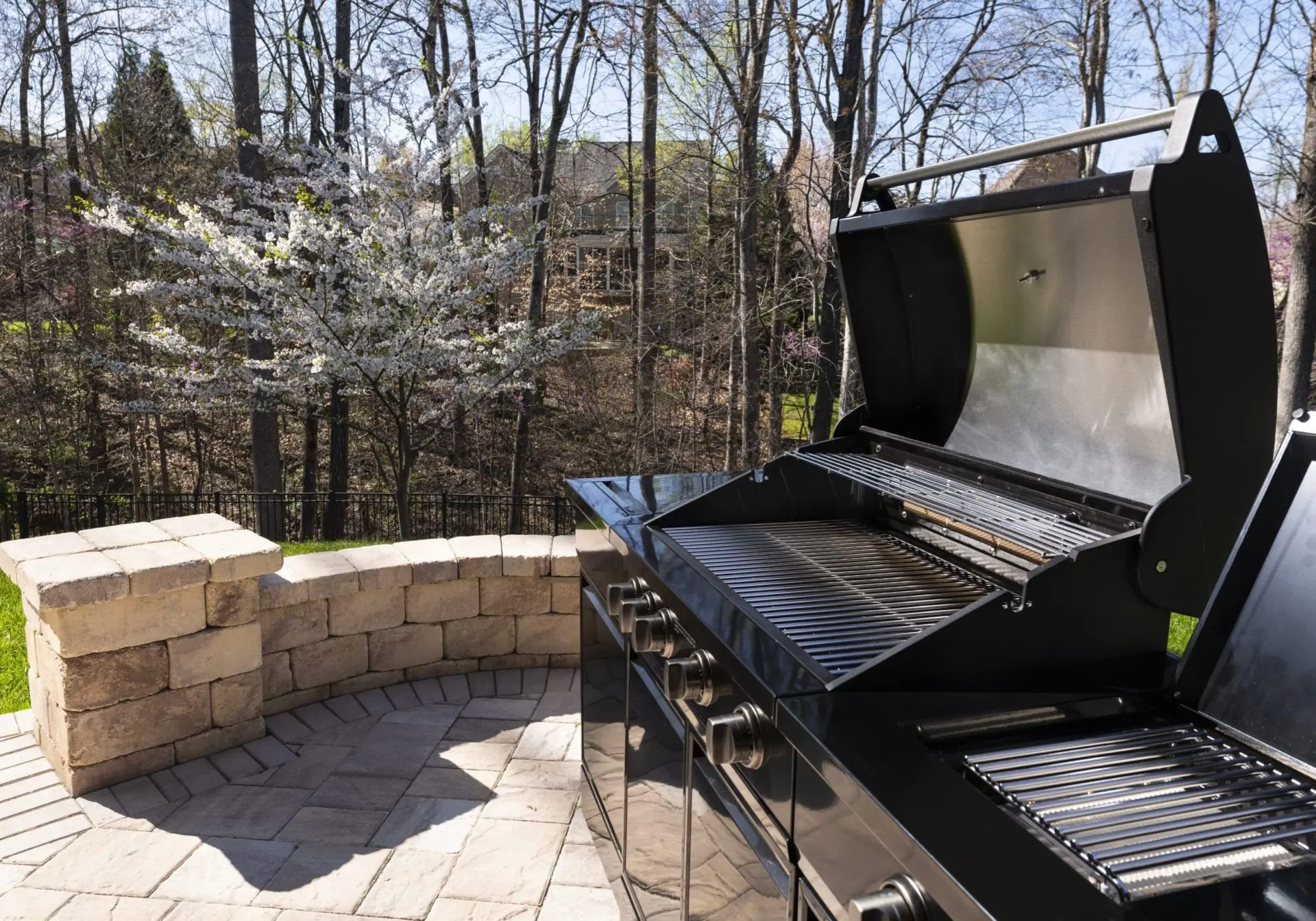 Outdoor barbecue grill on a sunny patio.