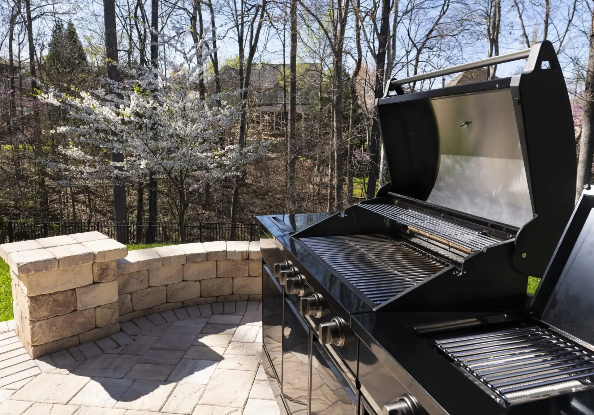 Outdoor barbecue grill on a sunny patio.